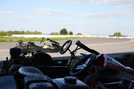 Racing cars for karting stand near the track before the start of the competition
