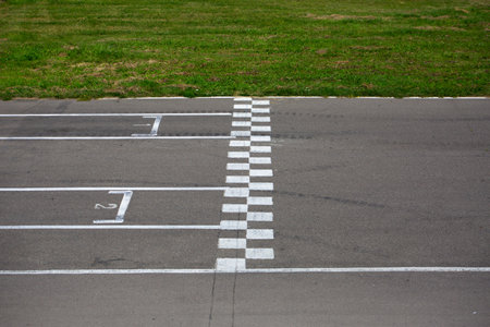 Finish line at the go-kart race track, side view. Asphalt track with markings for the correct start of the car and the finish lineの写真素材