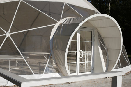 White tent for a party in the park. Dome-shaped building for weddings, holidays and outdoor weekends...