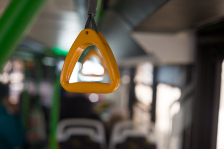 Yellow holder for grip on the bus on the handrail on the ceiling while riding while standing in public transportの写真素材