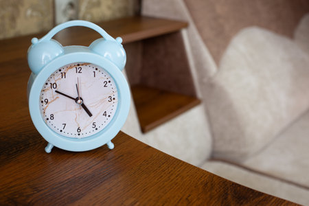 Alarm clock to notify bedtime is on shelf of home sofa in rest room, health benefits of sleep and...