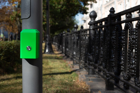 Button for changing the traffic light mode at pedestrian crossing. Button for pedestrians on pole to change traffic light signal to cross the roadの写真素材