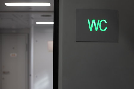 Toilet sign for men and women on train, toilet icon in the form of green WC inscription in public transport, restroom designation for transport passengersの写真素材