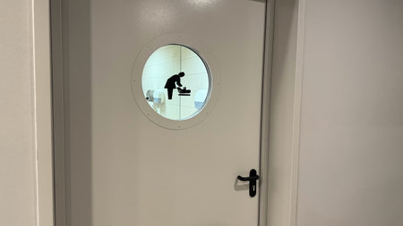 Door to baby changing room with symbol on glass window in public place, comfortable space with care...