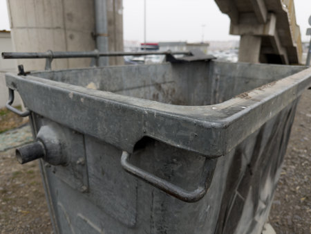Close up photo of gray metal waste bin. Creation of trash cans on the street for cleanliness of the city. Recycling waste after collecting it in special trash can. Old garbage cart for large garbageの写真素材