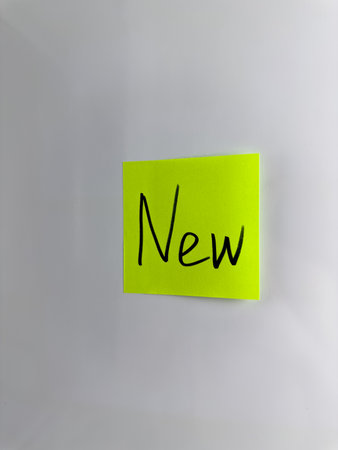 New. Concept of something new and fresh. The word New is written with marker on sticky note....