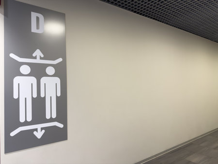 Modern elevator sign showing two human figures and up and down arrows on gray background with the...