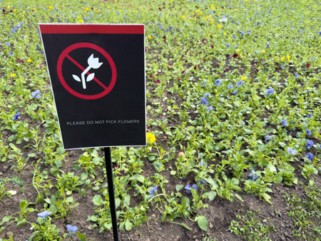 Clear symbolic sign with crossed out flower against a vivid field illustrates effective visual...