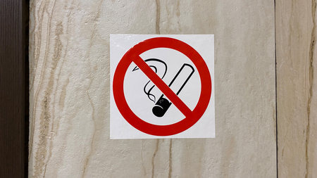 No smoking sign with bold red prohibition circle and cigarette icon clearly displayed on smooth...