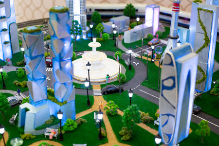 Detailed miniature model of modern city with buildings, streets, trees, and a fountain. Perfect representation for urban planning, architectural design and scale model enthusiastsの写真素材