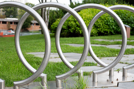 Modern stainless steel circular structure in urban park design. Contemporary outdoor architecture element symbolizing minimalism, geometry, and city improvementの写真素材