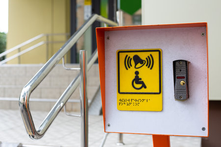 Accessible environment for people with disabilities. Assistance in climbing stairs in public place. Button to call staff for people in wheelchair. Care for incapacitated citizensの写真素材