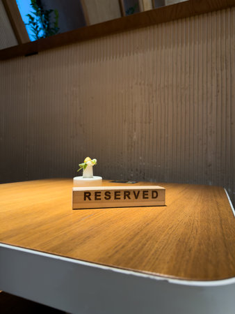 Reserved sign on wooden table with clean lines and soft lighting, symbolizing thoughtful planning and careful decision making. Ideal for projects focused on mindful choices and productivityの写真素材