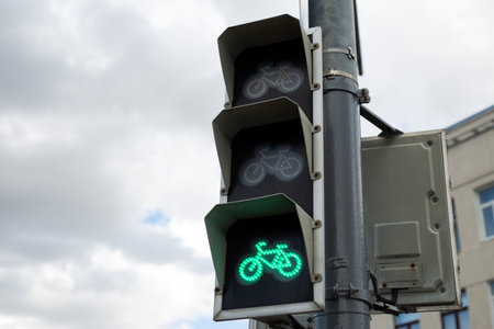 Green bicycle signal light showing go, indicating safe passage for cyclists. Symbolizing modern urban mobility and growing importance of bicycle infrastructure for eco friendly transportationの写真素材