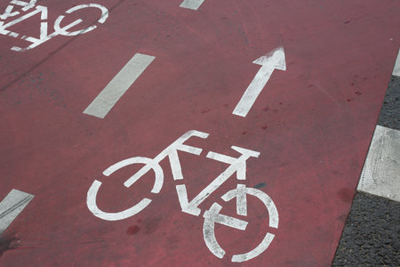 Bike lane markings with arrow, symbolizing forward movement and the encouragement of an active, eco friendly lifestyle. Perfect for campaigns promoting cycling and urban mobilityの写真素材