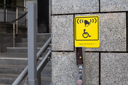 Clear and accessible sign indicating a call button for disability assistance, ensuring smooth access for people with mobility challenges in urban spaces. Essential for inclusive designの写真素材