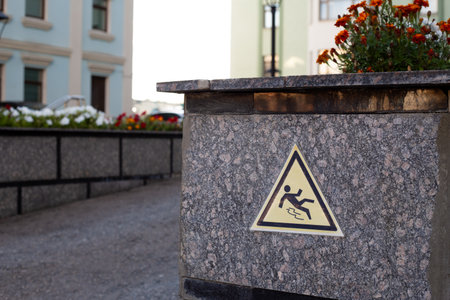 Cautionary sign indicating the risk of slipping in an area with a potential hazard. Such signs help raise awareness about safety in public spaces, ensuring the well being of pedestriansの写真素材