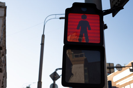 Red pedestrian traffic light shows dont walk signal, part of modern digital system ensuring safety for pedestrians in urban areas. Everyday life in contemporary citiesの写真素材