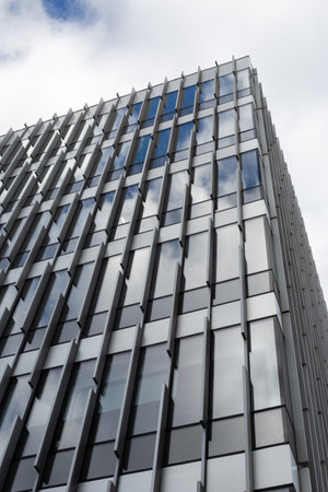 Close up shot of modern facade built with sleek, sustainable materials. The use of glass and metal...