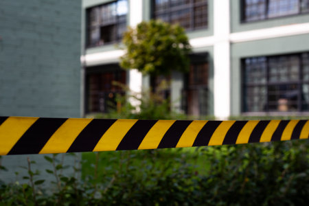 Close up of caution tape symbolizing emergency or accident scene. The yellow and black stripes...