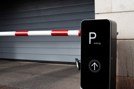 Parking gate with red and white barrier arm and Parking sign. This image highlights modern urban...