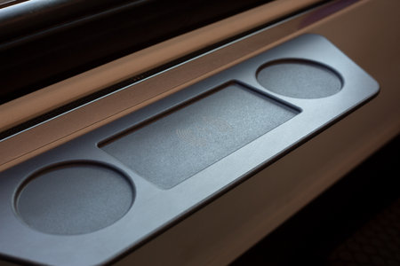 Close up of phone charging panel in train, featuring wireless charging capabilities for passengers....