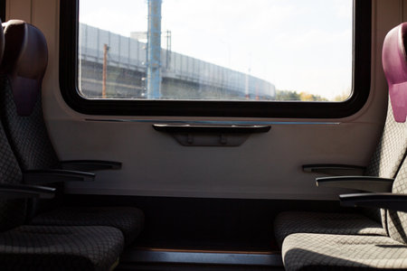 Tranquil shot of empty seat inside modern train carriage, suitable for themes of solitude,...