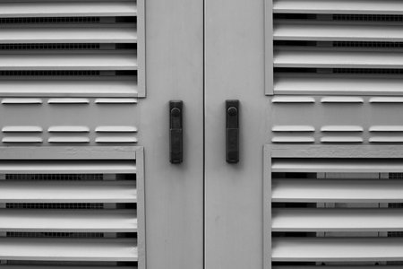 Industrial ventilation grilles with horizontal slats. Geometric design, in black and white tones, emphasizes texture and functionality, for architectural, industrial and design themesの写真素材