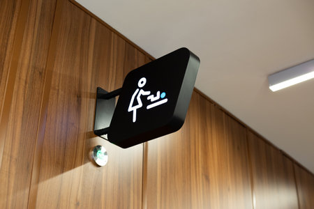 Modern public space interior designs location of diaper changing room for child. Universal sign helps silently indicate the location of this important room for parents caring for their childrenの写真素材