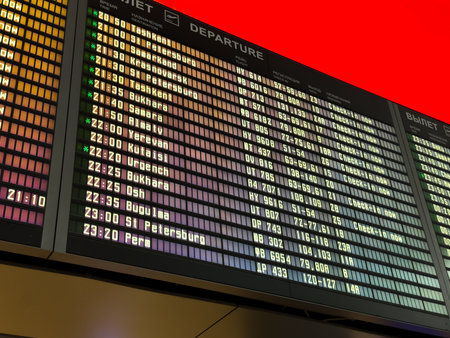 Online flight departure board at the airport. Flight schedules are displayed on the screen. Modern online board with flight numbers and departure timesの写真素材