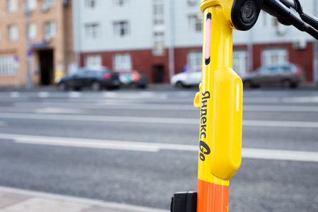 Moscow, Russia, November 16, 2025: Close up photo of Yandex Go logo on handlebars of electric scooter. Scooter for rent from Yandex. Article about Yandex vehicle rental eventのeditorial素材