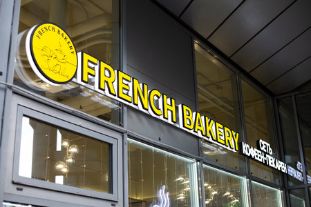 Moscow, Russia, November 16, 2025: French Bakery Sedelice coffee shop and bakery with yellow illuminated sign and logo of popular chain of cafes and bakeriesのeditorial素材