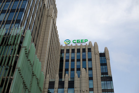 Moscow, Russia, November 16, 2025: Sber sign and logo on the roof of the Oruzheyny business center. Plaque Sberbank on building. News about Sber stocks and bonds on stock exchangeのeditorial素材