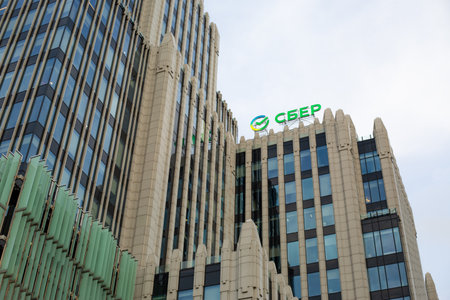 Moscow, Russia, November 16, 2025: Green Sber logo with arrow shaped logo. Office of developed Sber company with sign on the roof of its headquarters. News and articles about Sberのeditorial素材
