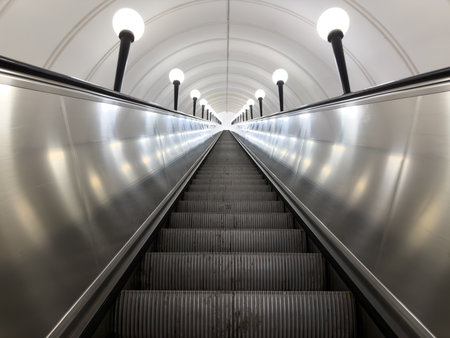 Symmetrical photo of long escalator going up. Concept of personal growth, career development, and successful success in life and work. Escalator leading upward to victory and achievementの写真素材