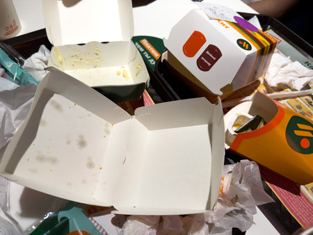 Moscow, Russia, November 21, 2025: Food boxes from Vkusno i Tochka with logo of Russian fast food chain. Fast food restaurant with food packaging. Tray for throwing away leftoversのeditorial素材