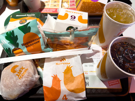 Moscow, Russia, November 21, 2025: Tray with order from Vkusno i Tochka. Burgers, nuggets and drinks on tray from the Russian fast food chain. Typical order at Vkusno i Tochka for two peopleのeditorial素材