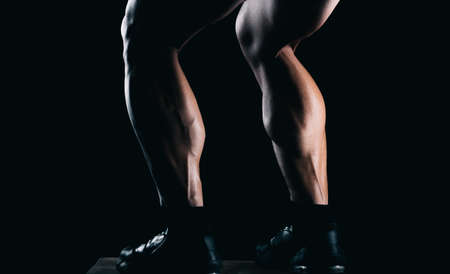 Strong mans calves with a black backgroundの写真素材