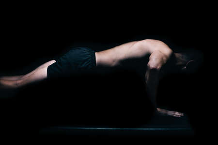 Profile of a fitness man doing push-ups.の写真素材