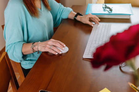 Adult woman teleworking from homeの写真素材