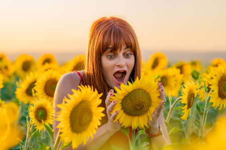 Expressive Woman in Sunflower Fieldの写真素材