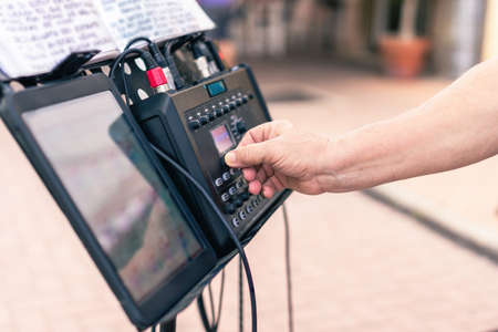 Close up view of a person preparing a device to perform a live concertの写真素材