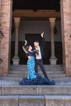 Vertical photo of flamenco dancers performing in stairs of a buildingの写真素材