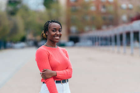 portrait of a young black woman with her hair tied back in braidsの写真素材