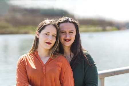 portrait of lesbian couple on out-of-focus backgroundの写真素材