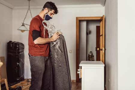worker placing the furniture in the destination apartment during a moveの写真素材