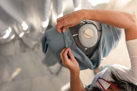 zenith shot of a seamstress placing a fabric on a mannequins shoulders