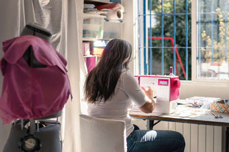seamstress working at home with a sewing machineの写真素材