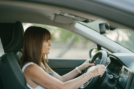 side view of the interior of a car with a female driverの写真素材