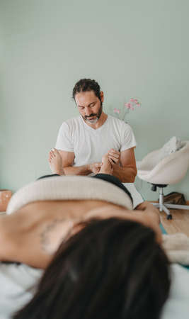 reflexology office technician working with a patients feetの写真素材